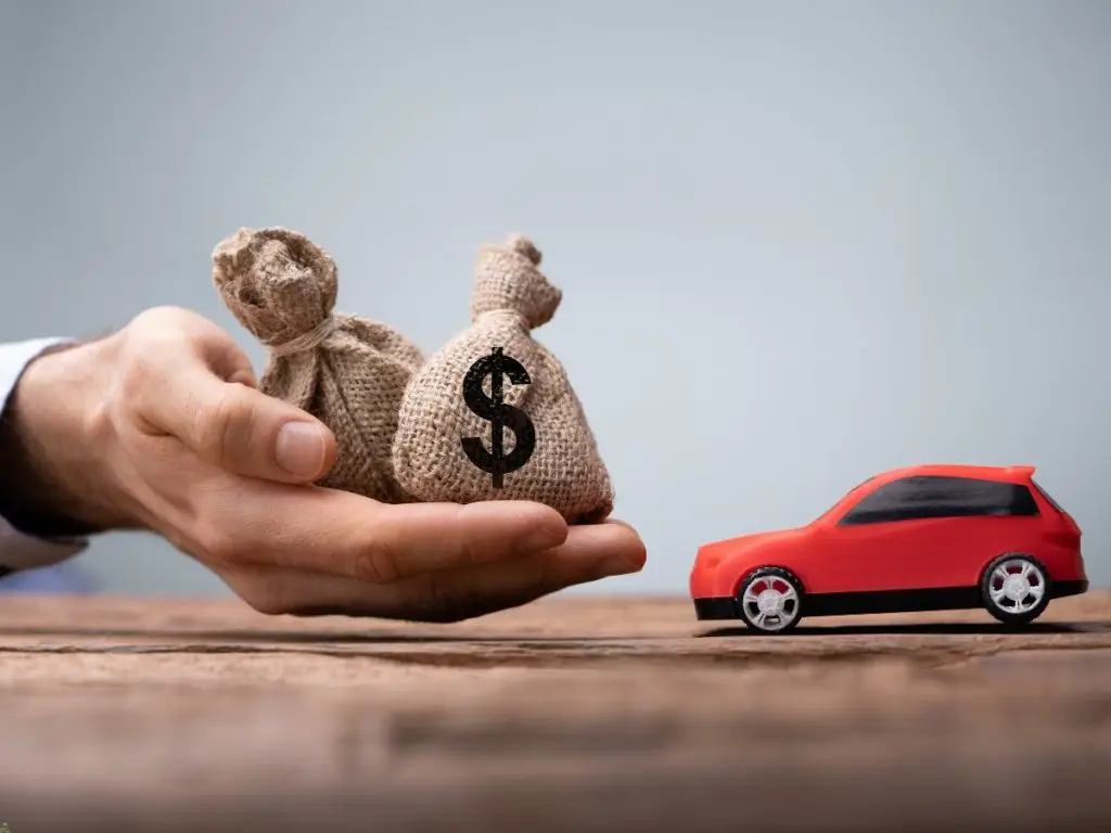 toy car and bags of money represent an auto title loan