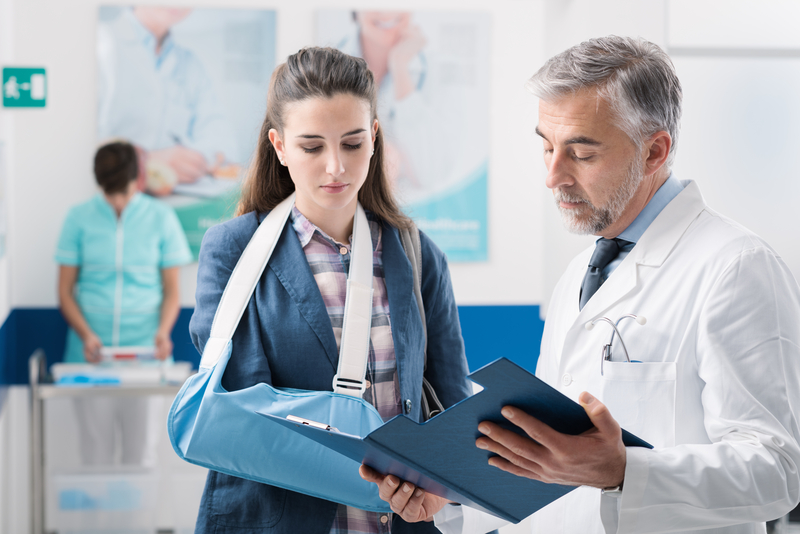 Doctor with a patient with broken arm