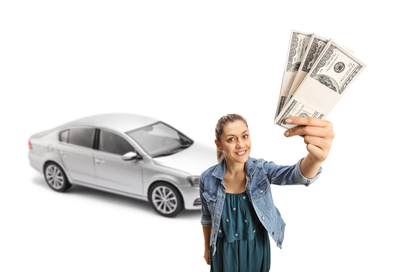 Young woman holding money from a car registration loan